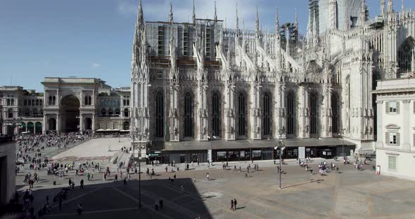 Tourists flooding Piazza del Duomo at Milan Cathedral, Italy; aerial riser