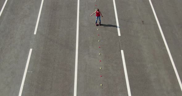 Young Woman Rollerblading Slalom