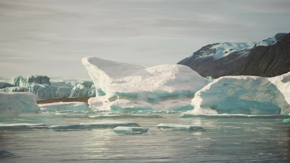 Snowcapped Mountains Against the Blue Ocean in Antarctica