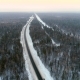 Intercity Highway Among Woodland at Sunset in Winter - VideoHive Item for Sale