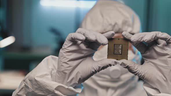 Hands of Lab Worker in Gloves Holding Chip