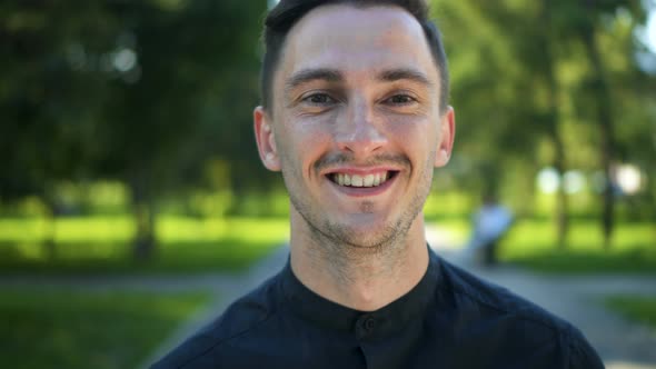 Portrait of a Confident Young Man Smiling Enjoying a Successful Urban Lifestyle.