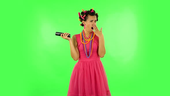 Woman with TV Remote in Her Hand, Switching on TV Bored. Green Screen