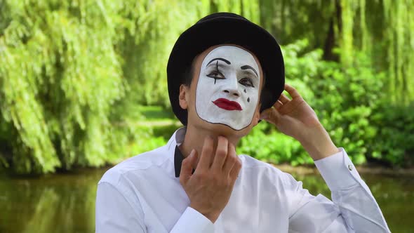 Funny Mime in a Black Hat on the Park