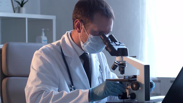 Professional medical doctor working in hospital office using computer technology.