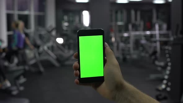 Sportsman Checking Online Smartphone Application, Monitoring Pulse and Calories