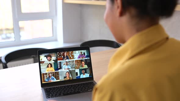 Feale Employee Involved Video Meeting on the Laptop with Diverse Workteam