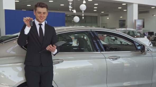 Sales Manager Shows Key at the Dealership