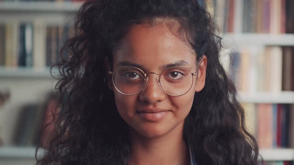 Happy Indian Teenage Girl Laughing at Funny Joke Looking at Camera in Library