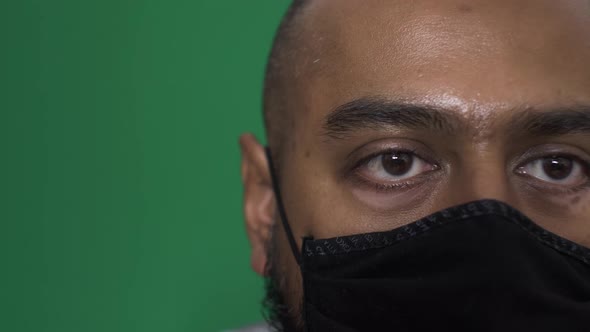 Adult Male Wearing Black Cotton Face Mask Indoors. Locked Off, Green Screen