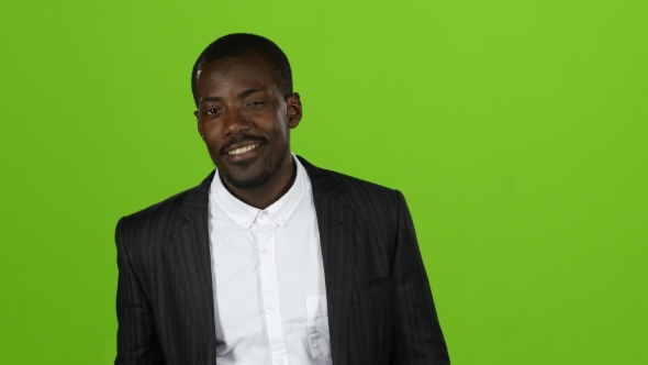 Businessman of an African American in a Suit Winks and Flirts. Green Screen