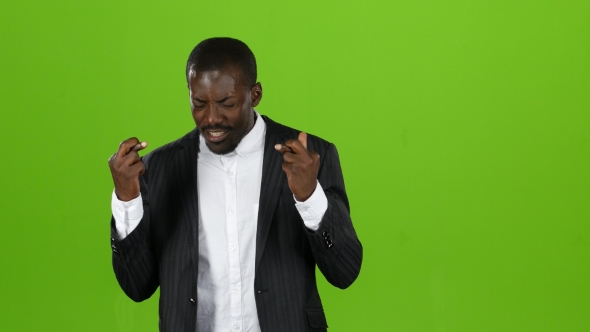 African American Crosses His Fingers, Hopes a Happy Occasion in His Endeavors. Green Screen