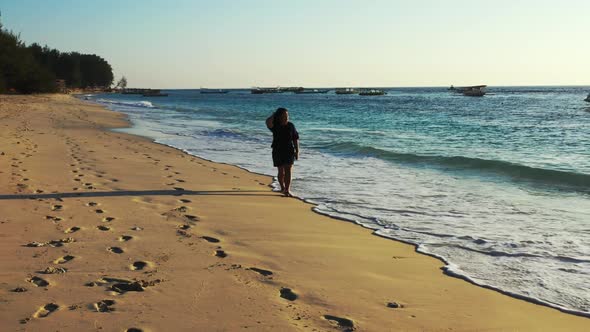 Tourist sunbathes on beautiful tourist beach break by blue green ocean with white sand background of