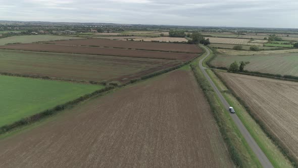 Aerial pull back tracking shot of utility vehicle in the Nottinghamshire Countryside