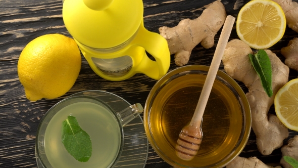 Ginger Tea with Lemon, Mint and Honey on Wooden Background.