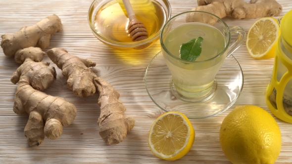 Ginger Tea with Lemon, Mint and Honey on Wooden Background.