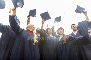  of happy international students in bachelor gowns waving mortar boards or hats