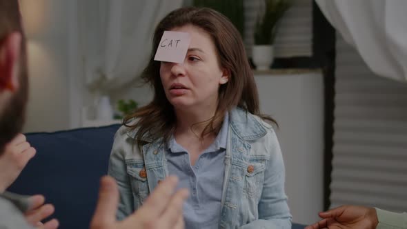 Mixed Race Friends Socializing During Entertainment Party While Playing Guess Who Game