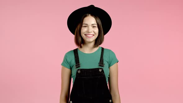 Young Smiling Woman with Red Hairstyle Looking To Camera. Portrait of Cute Beautiful Girl on Pink