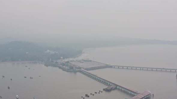 Reveal drone shot of full mandwa jetty on a hazy day