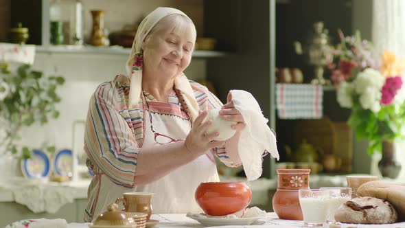 Babushka Senior Woman Cooking Cottage Cheese in Country