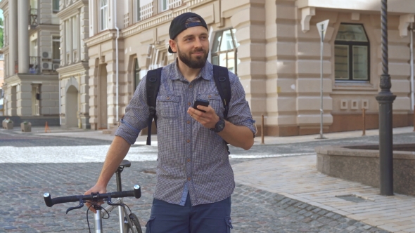 Cyclist Uses Cellphone on the Street