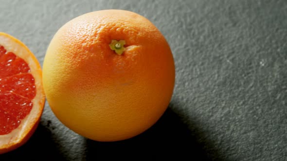 Grapefruit with half grapefruit on grey background 