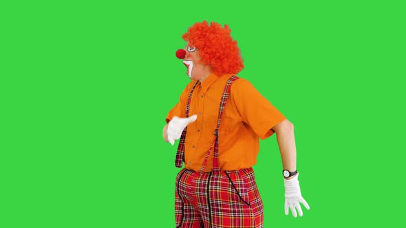 Funny Clown Being Late Looking at His Watch but Takes It Easy on a Green Screen Chroma Key