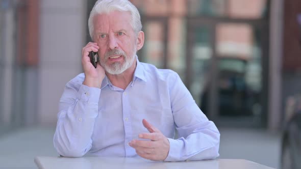 Outdoor Angry Old Man Having Argument on Smartphone