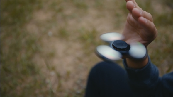 Boy Plays with Fidget Spinner