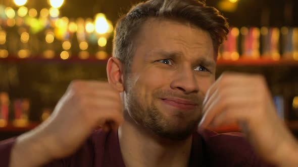 Emotional Caucasian Male Fan Watching Sport Game in Pub, Frustrated About Defeat