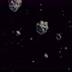 Animation of small and large asteroids drifting in galaxy and stars in background - VideoHive Item for Sale