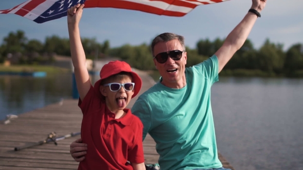 Young Boy and His Father with the American Flag