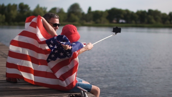 Father and Son Posing with American Flag