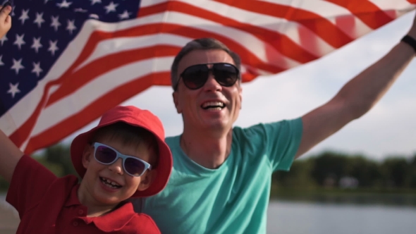 Young Boy and His Father with the American Flag