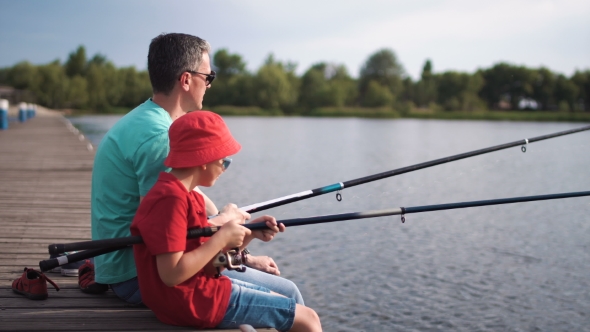 Man and Boy Fishing on Pier