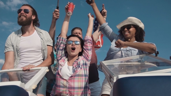 Group of Cheering Laughing Friends on a Speedboat