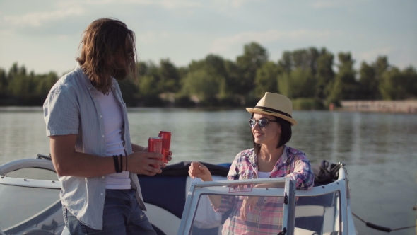 Young Couple Toasting Each Other in a Motorboat