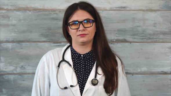 Portrait of a Young Therapist Woman Who Is Wearing a White Robe and Stethoscope