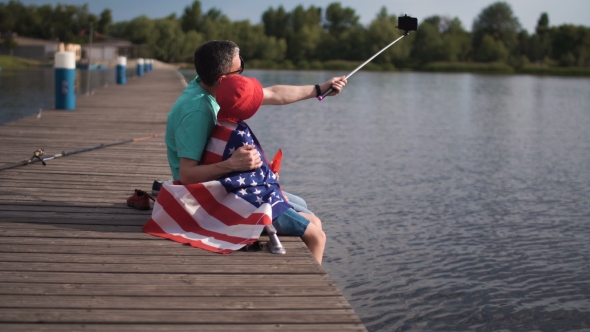 Father and Son Posing with American Flag