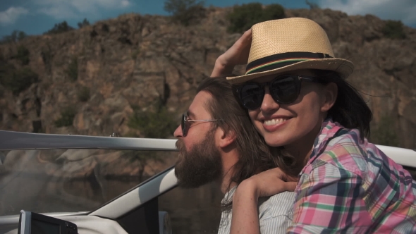 Young Couple Speeding Along in a Motorboat