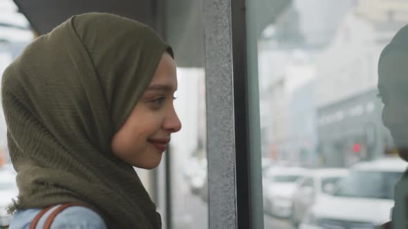 Woman wearing hijab looking at shop window