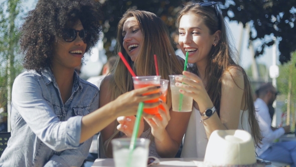 Smiling Women Clinking Glasses