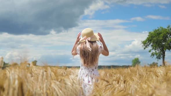 Girl Walking on Barley Field