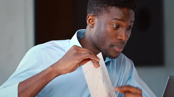 Young male showing infographic via video call with colleagues