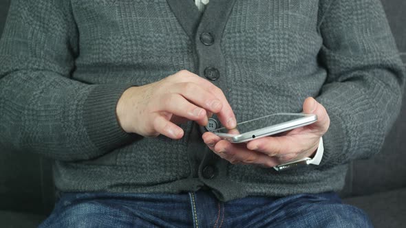 Elderly Man Uses A Tablet Indoors