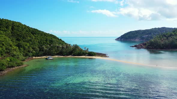 Wide angle overhead abstract view of a sandy white paradise beach and blue sea background in colourf