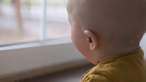 close-up portrait of a kid by the windowclose-up portrait of a