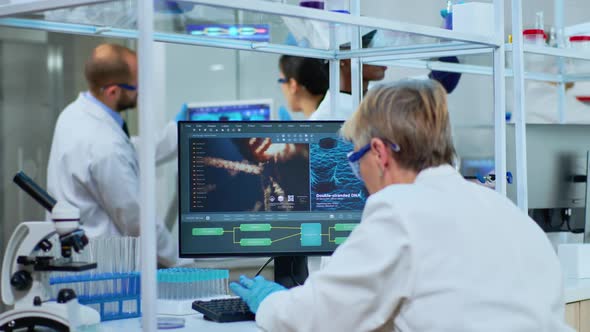 Medical Research Scientist Typing Codes on Computer