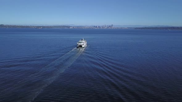 Aerial left to right movement of Seattle Ferry and downtown Seattle in the distance.
